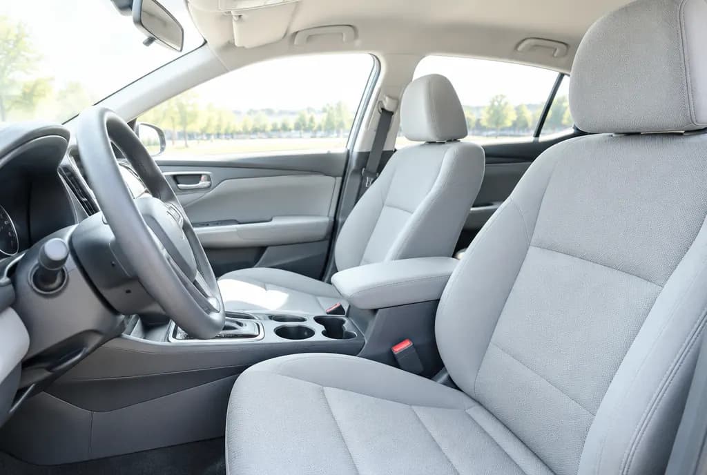 Clean front seats and steering wheel in a bright car interior